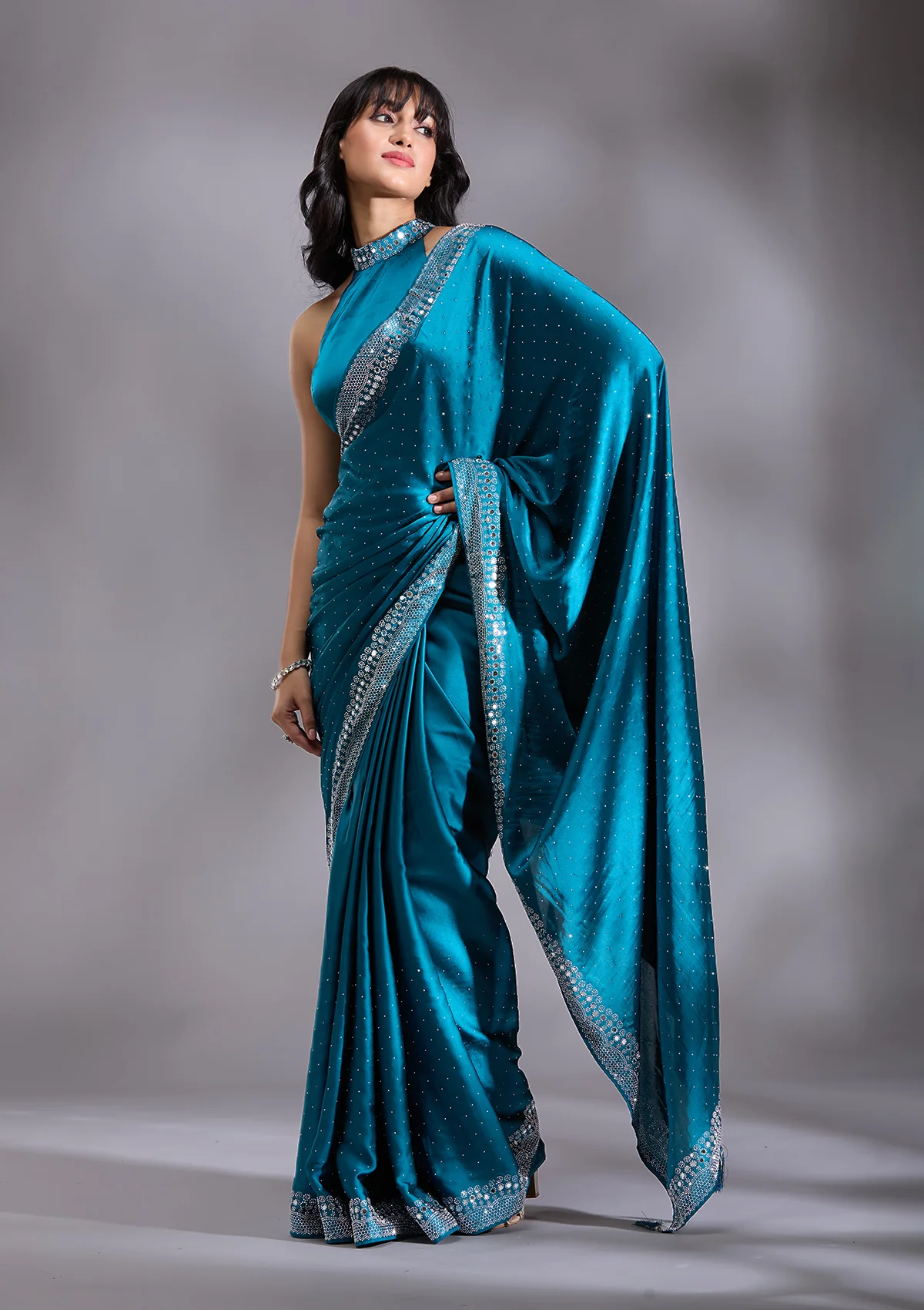 SAUS0044270_PEACOCK_BLUE_4_97b426be-65a3-4e86-a532-962f2cc4ff76.webp Peacock Blue Silver Stonework Satin Saree - Image 1